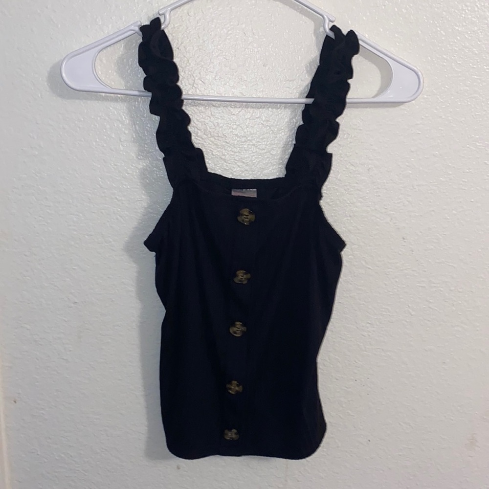 A black tank top with buttons